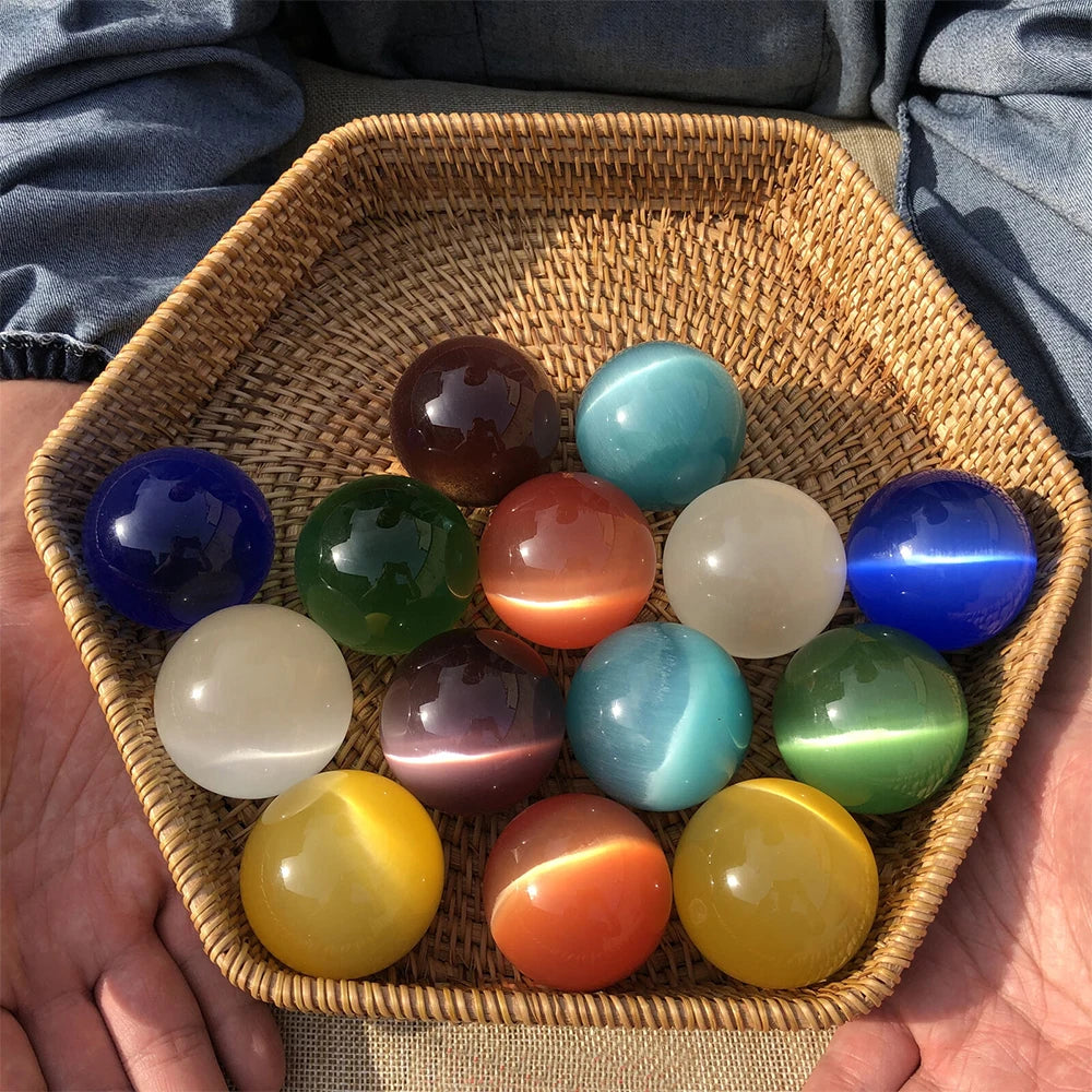 Wicker basket filled with colorful marbles held by a person.