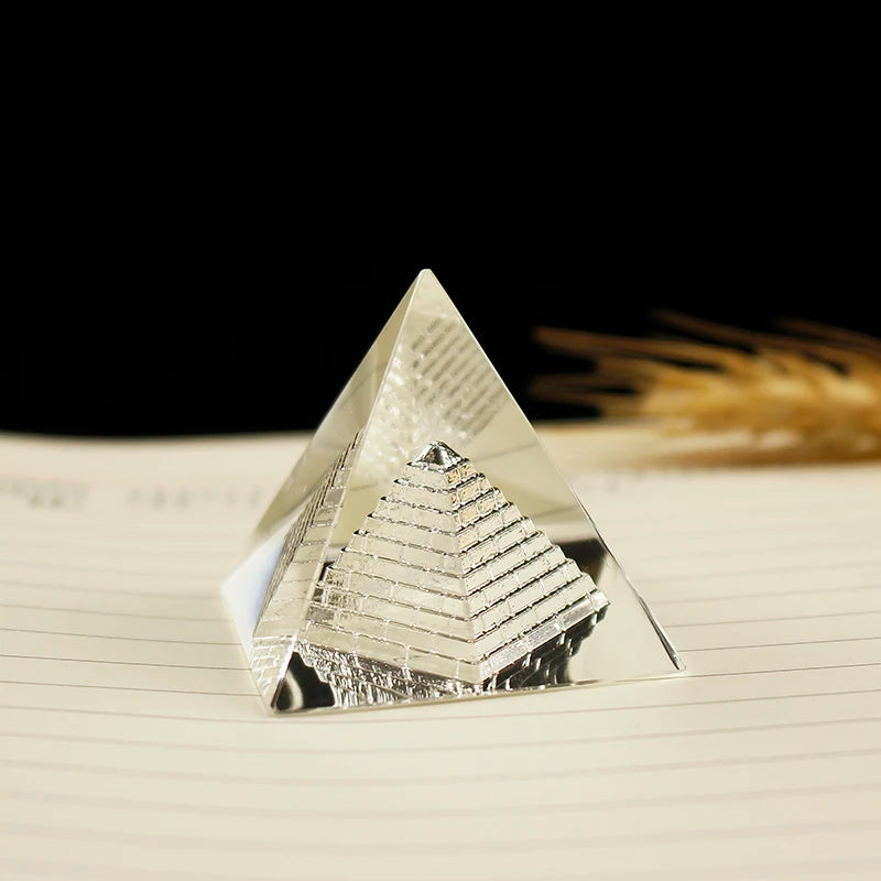 Crystal pyramid on a piece of paper with a black background