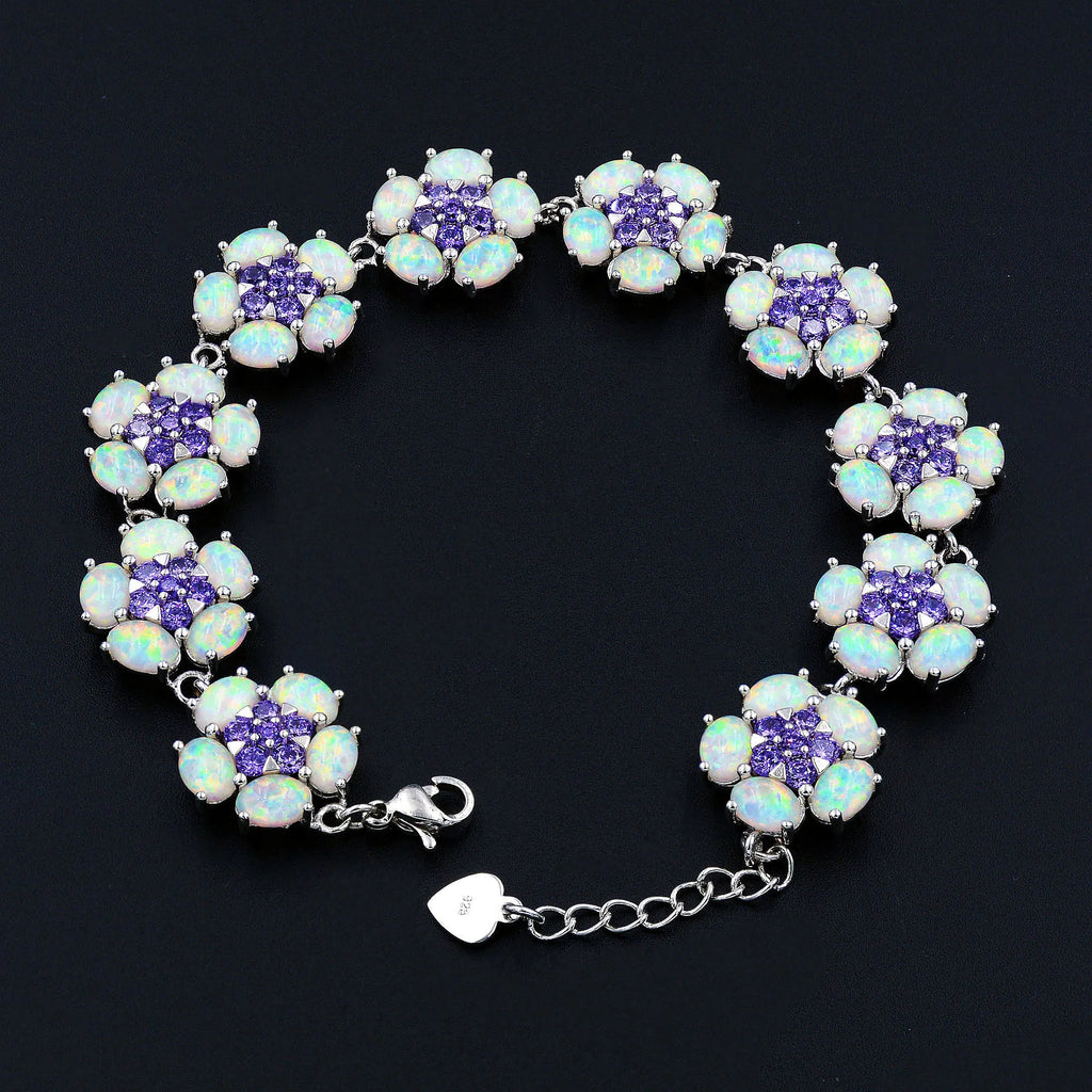 Bracelet with floral design featuring purple and white stones on a black background