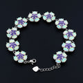Bracelet with floral design featuring purple and white stones on a black background