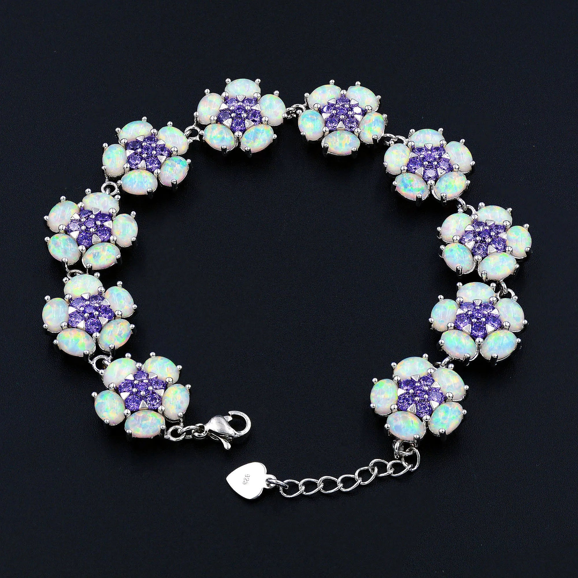 Bracelet with floral design featuring purple and white stones on a black background
