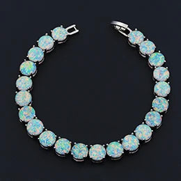 Opal bracelet with silver clasp on a black background