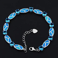Blue beaded bracelet with silver clasp on a black background