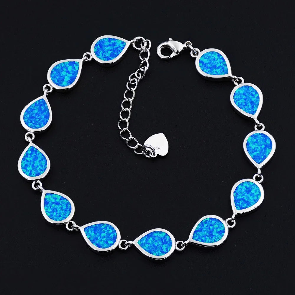 Silver bracelet with blue teardrop-shaped stones on a black background