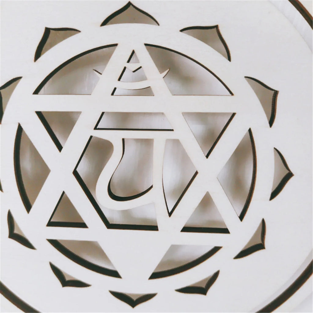 Decorative white object with geometric cut-out design on a light background