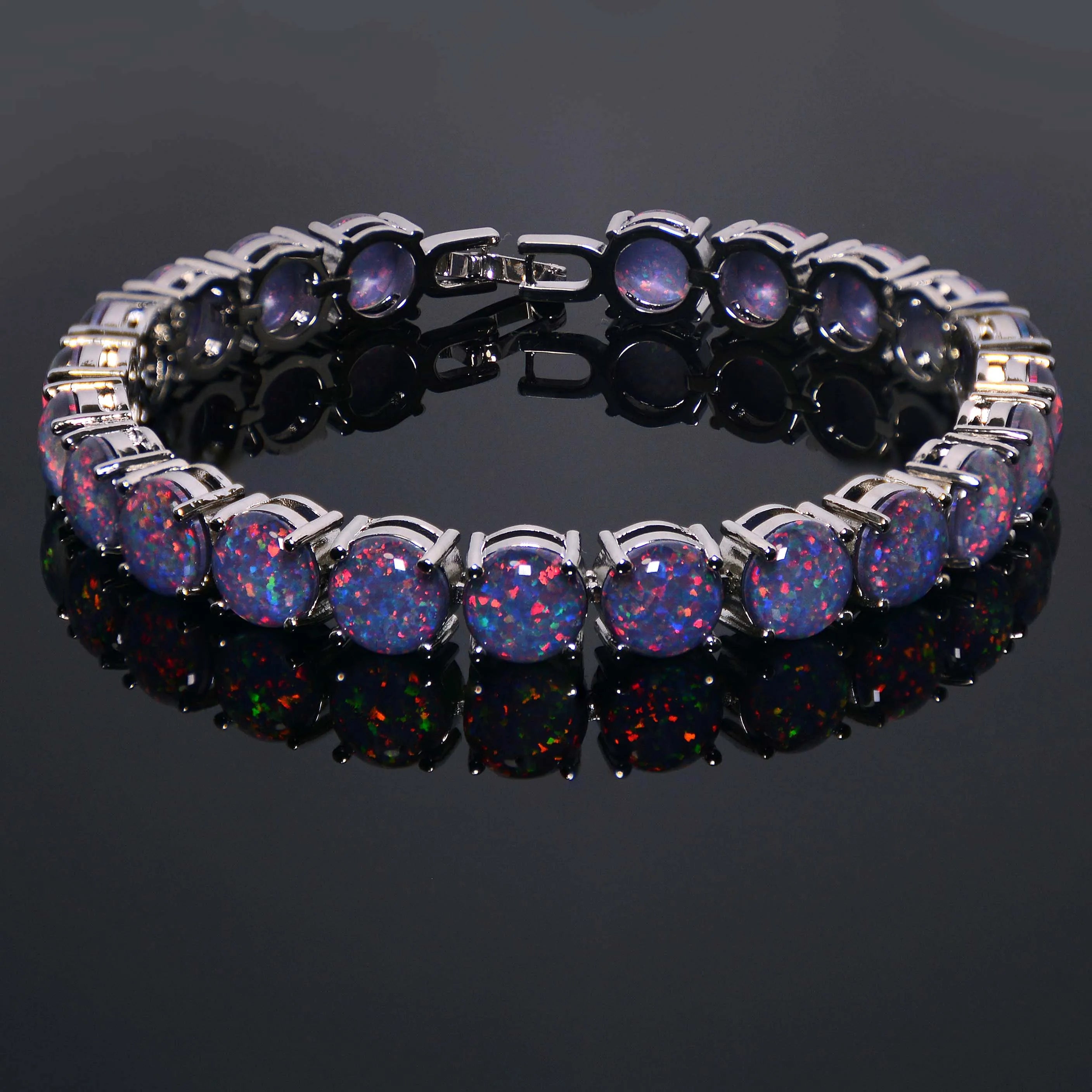 Bracelet with colorful gemstones on a reflective black surface