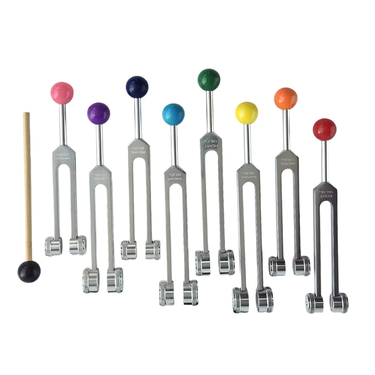 Set of tuning forks with colored ends on a white background