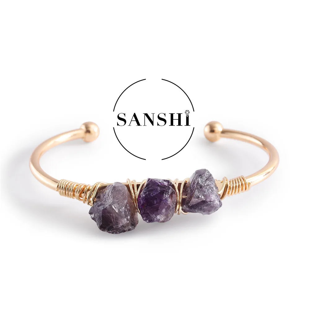 Gold bracelet with purple stones on a white background, featuring the brand 'SANSHI'.