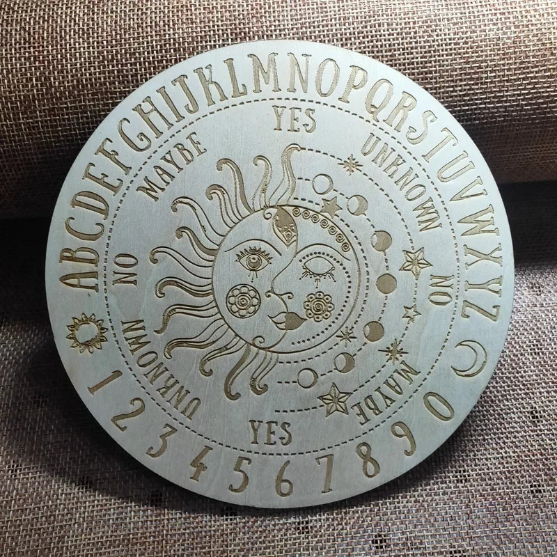 Ouija board with sun and moon design on a textured fabric background