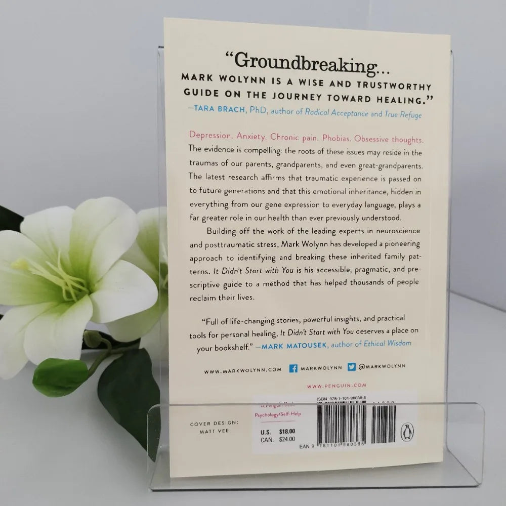 Book back cover with text and a flower on a gray background