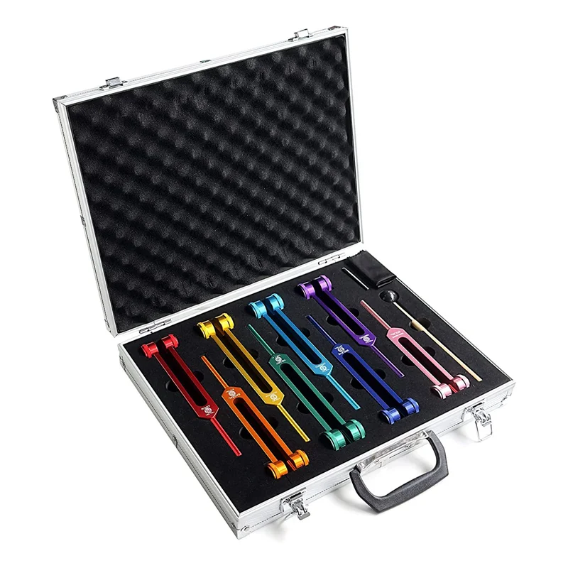 Set of colorful tuning forks in an open metallic case on a white background