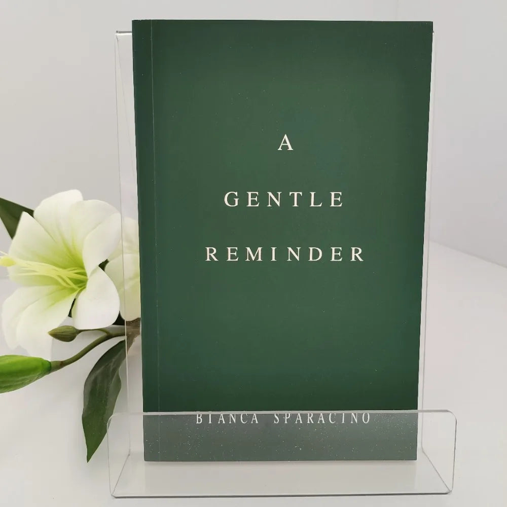 Book titled 'A Gentle Reminder' by Bianca Sparacino with a white flower on a light gray background