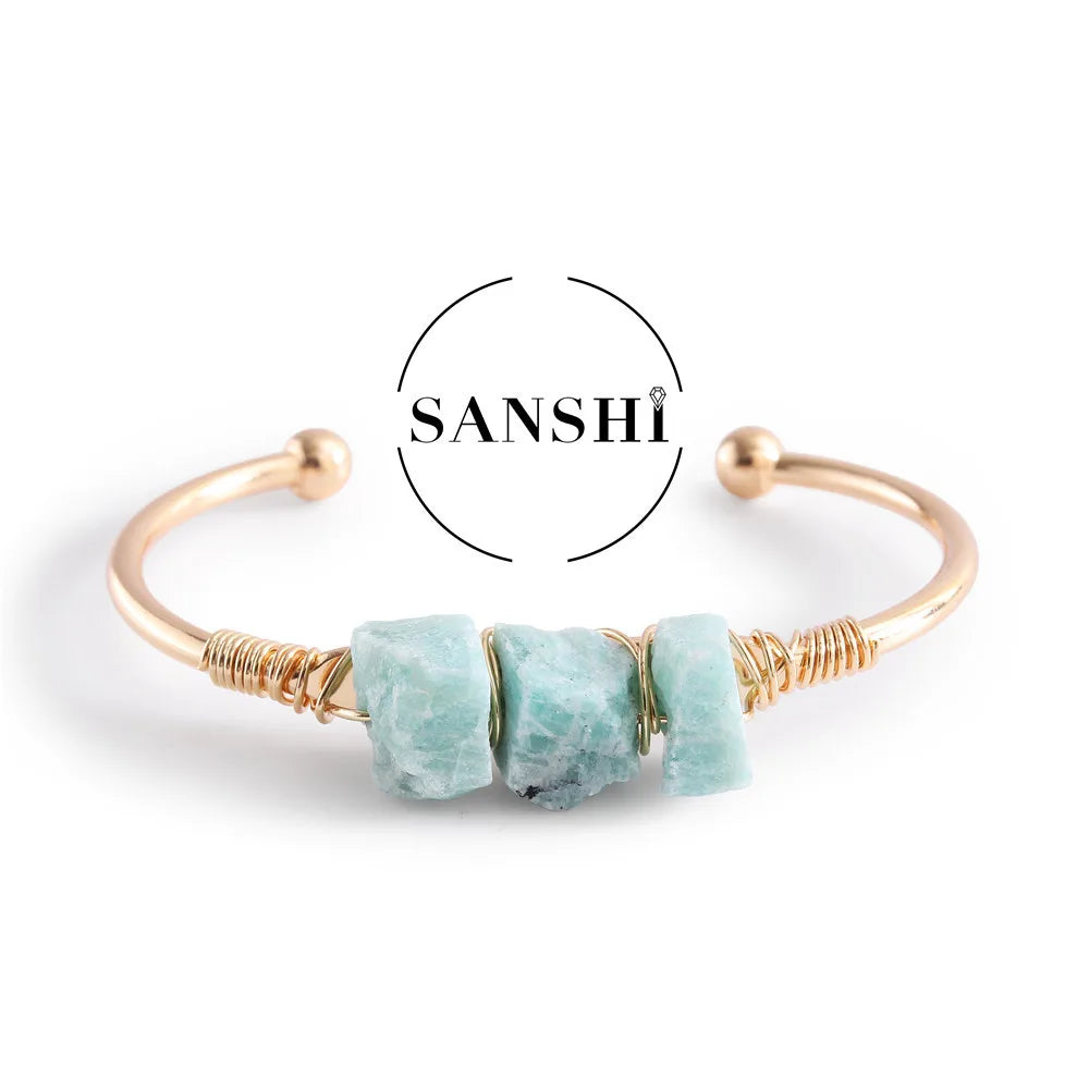 Gold bracelet with turquoise stones on a white background, featuring the brand 'Sanshi'.