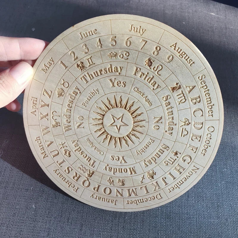 Circular wooden calendar with embossed text and symbols on a blue fabric background