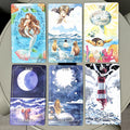 Set of tarot cards with various illustrations and text on a flat surface.