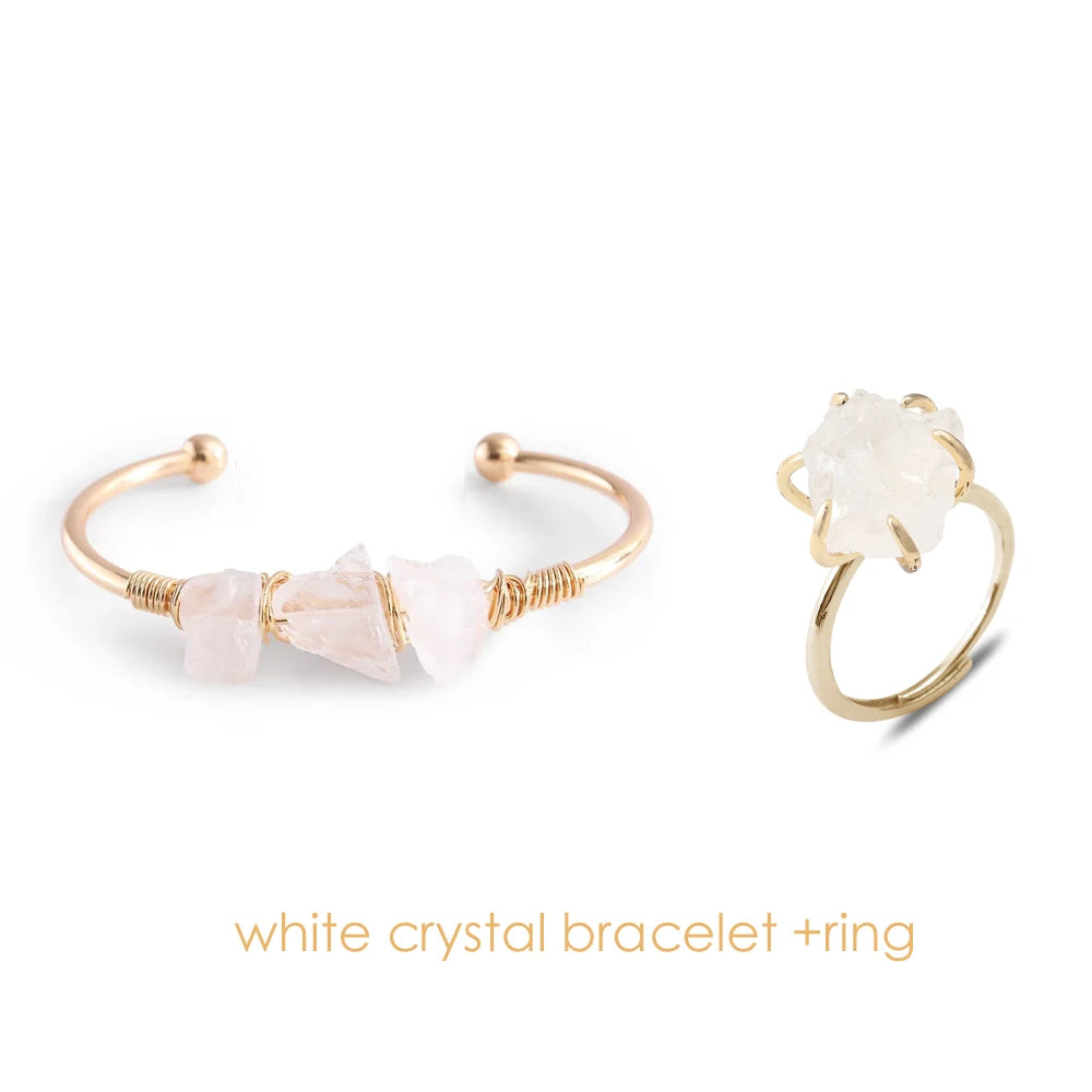 Gold bracelet and ring with white crystals on a white background