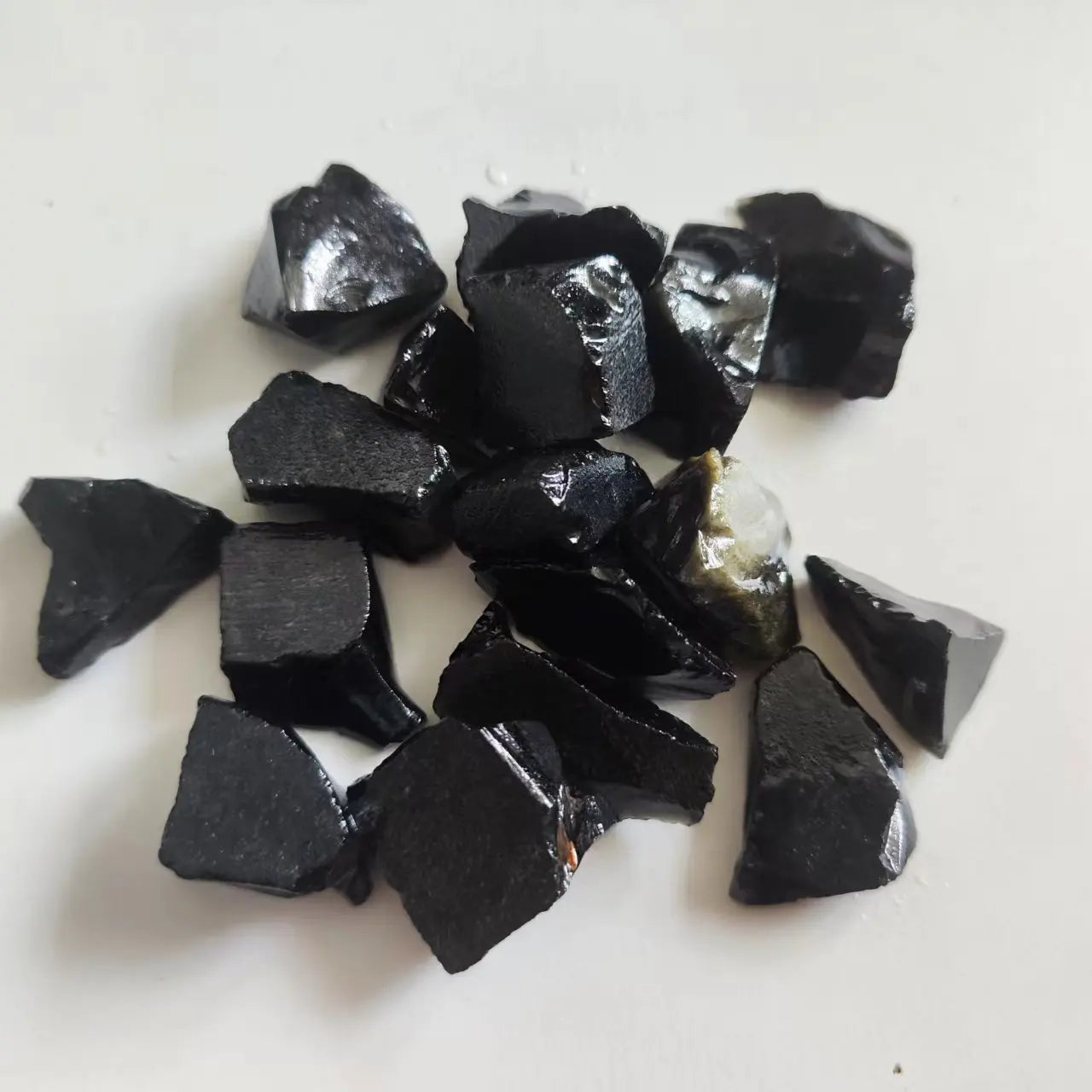 Collection of dark stone chips on a light background