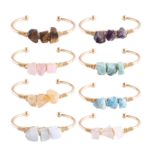 Set of eight gold-framed crystal bracelets on a white background