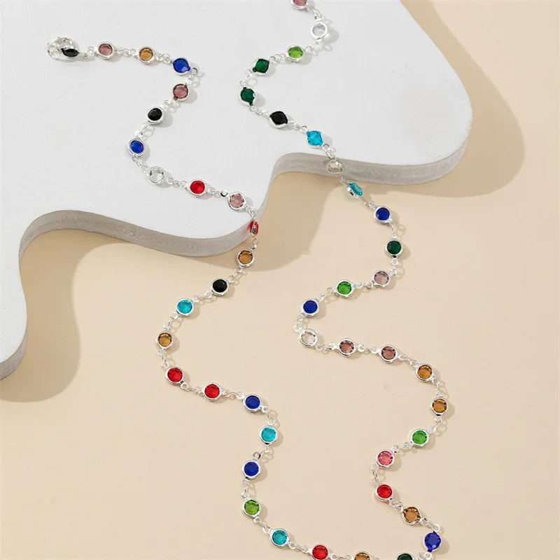 Colorful beaded necklace on a beige surface