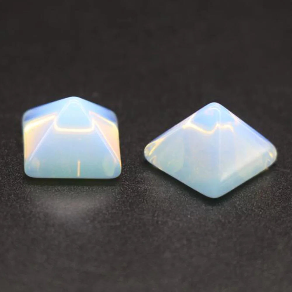 Two faceted gemstones on a dark background