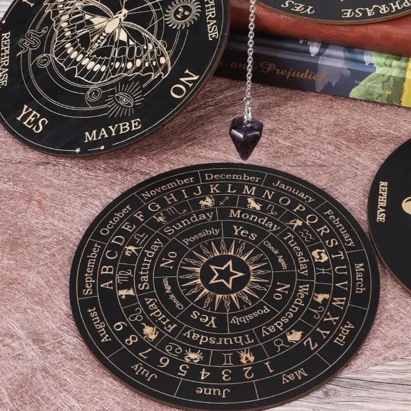 Black circular fortune teller with yes/no options and astrological symbols on a wooden surface.