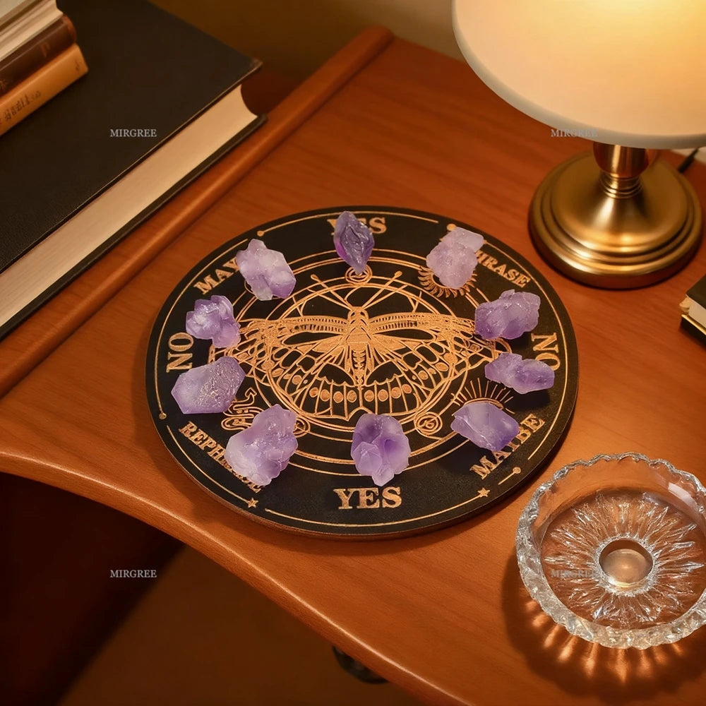 Crystal grid with purple crystals on a black board with yes/no and maybe choices, placed on a wooden surface with a lamp and books.