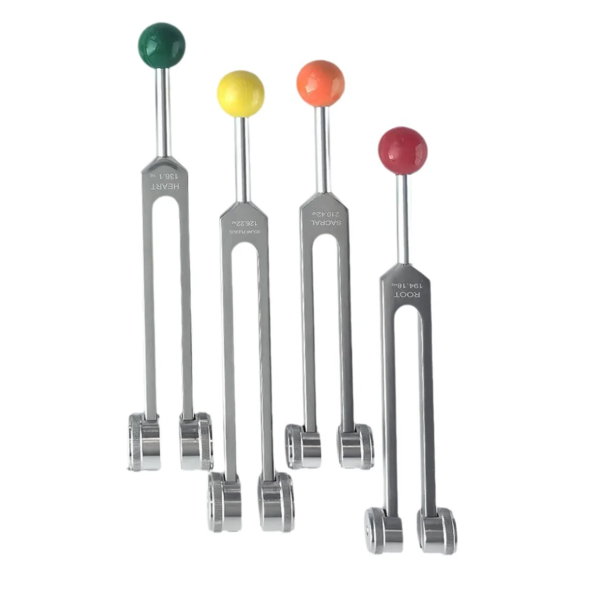 Set of four tuning forks with colored ends on a white background