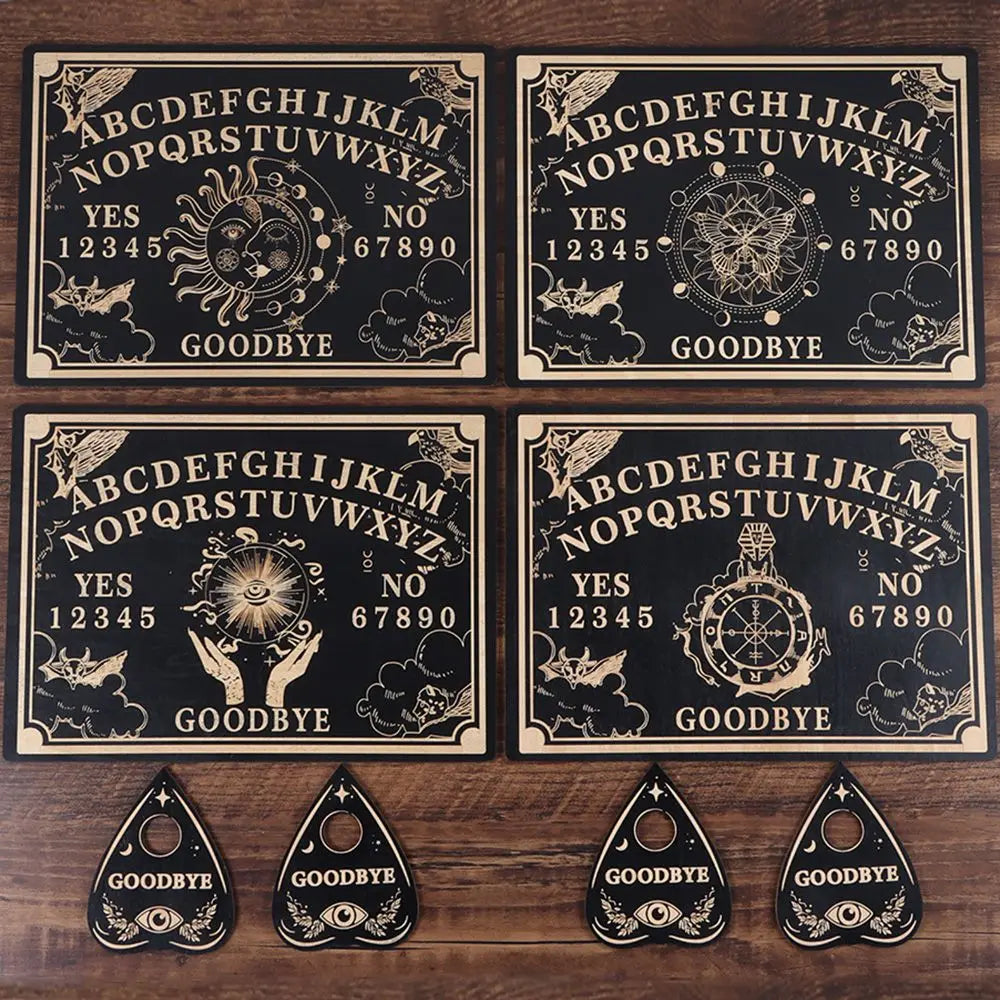 Set of Ouija board designs and related accessories on a wooden surface