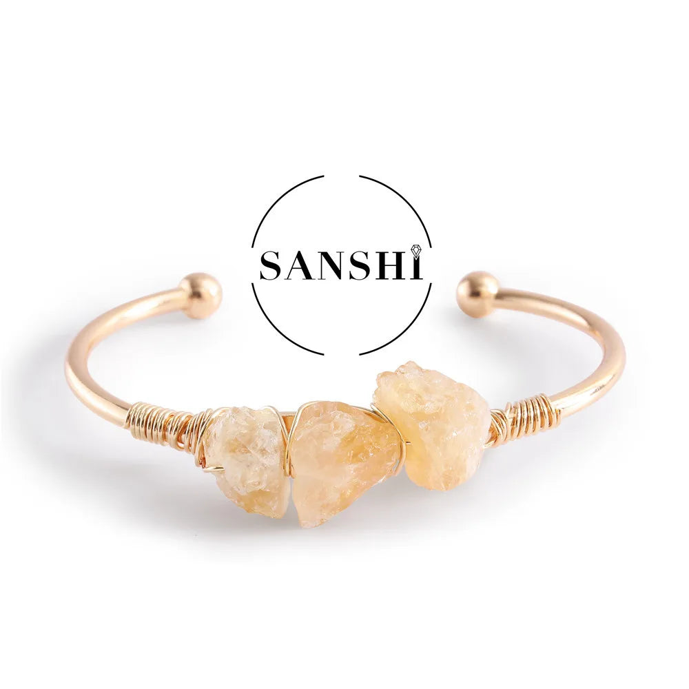 Gold bracelet with natural stone beads on a white background, featuring the brand 'Sanshi'.