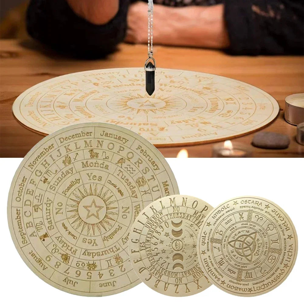 Set of circular astrological charts with a crystal on top, displayed against a wooden surface.