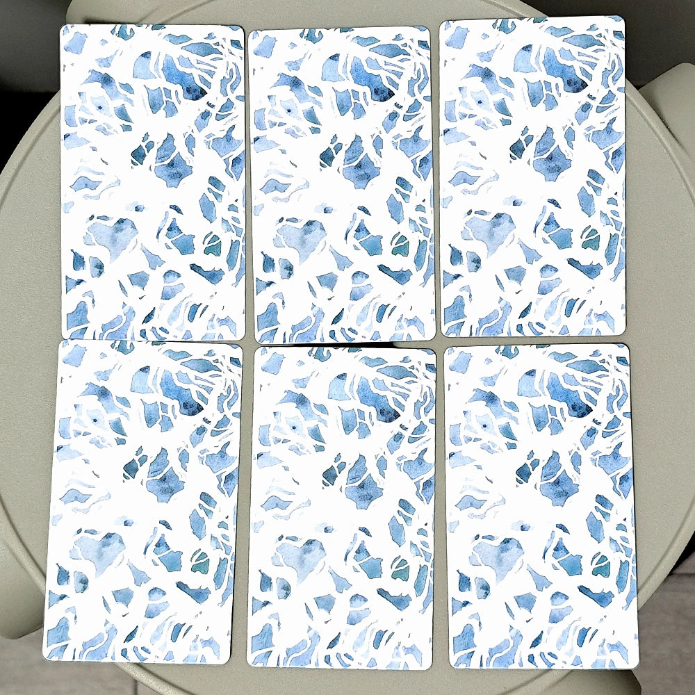 Six blue and white patterned tiles on a circular surface