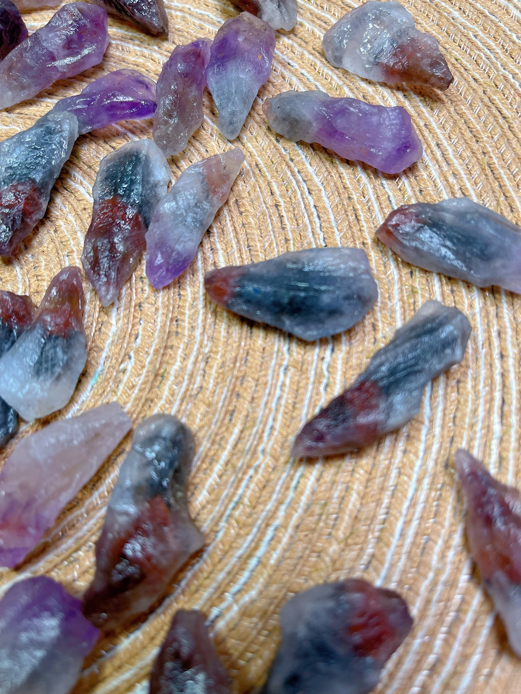 Purple and red crystal pieces on a wooden surface