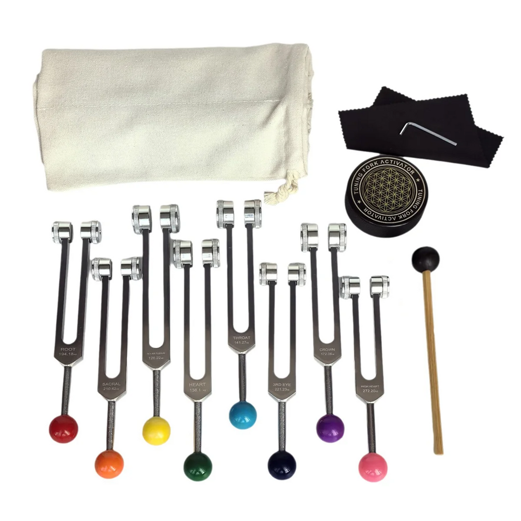 Set of tuning forks with colored balls, a cloth pouch, and a mallet on a white background