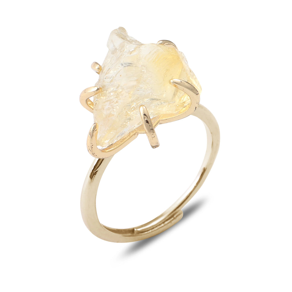Gold ring with a large, rough-cut gemstone on a white background