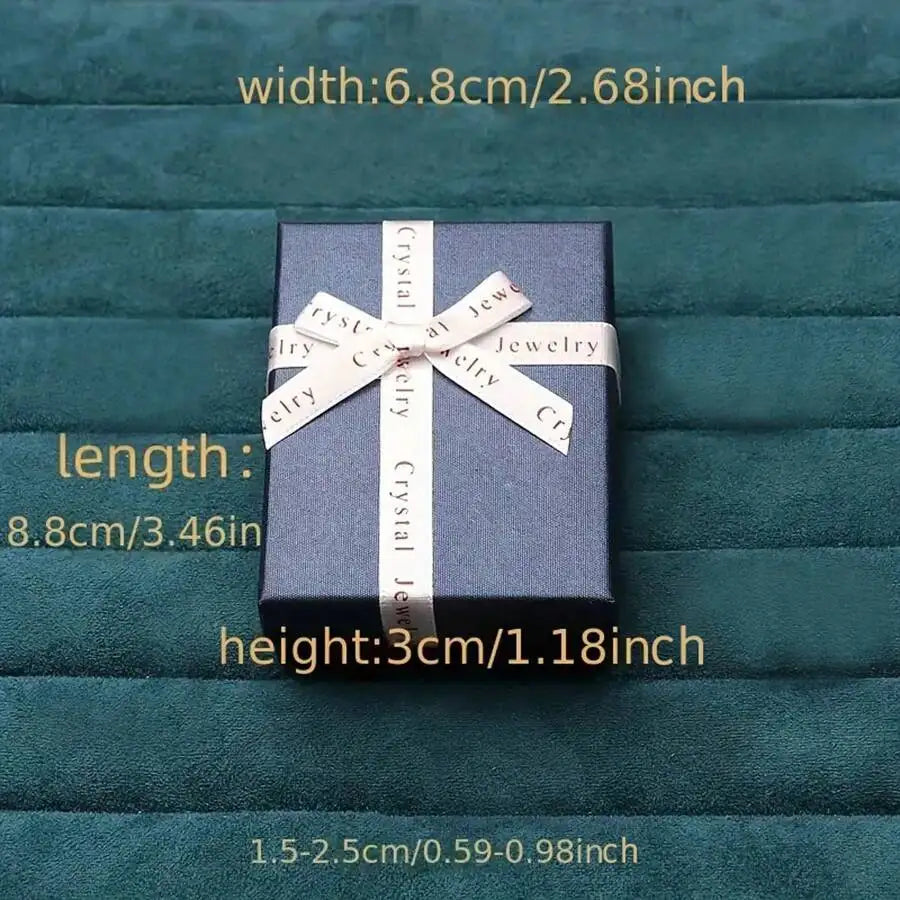 Blue gift box with a white ribbon on a textured green background