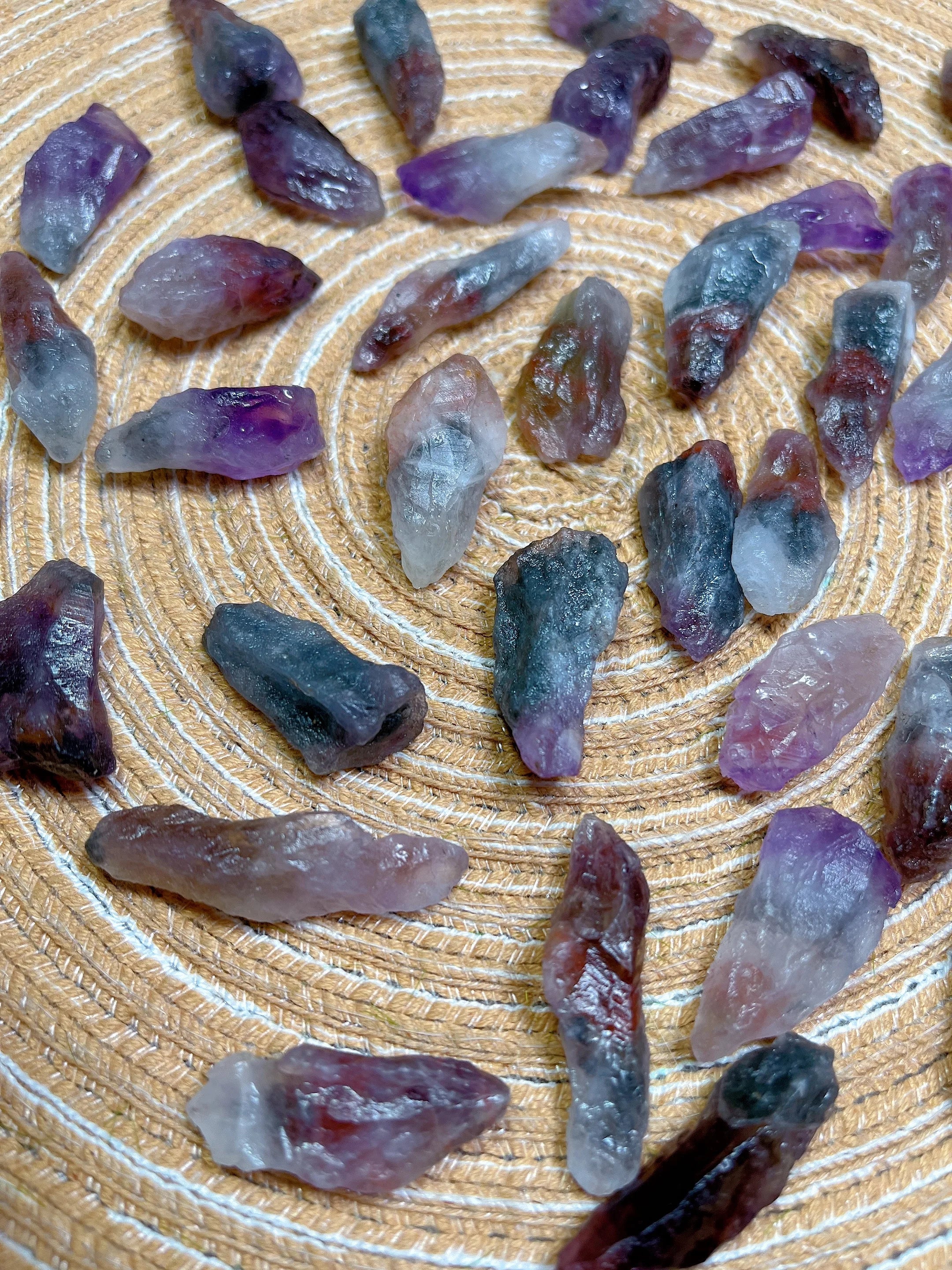 Collection of purple and gray crystals on a wooden surface