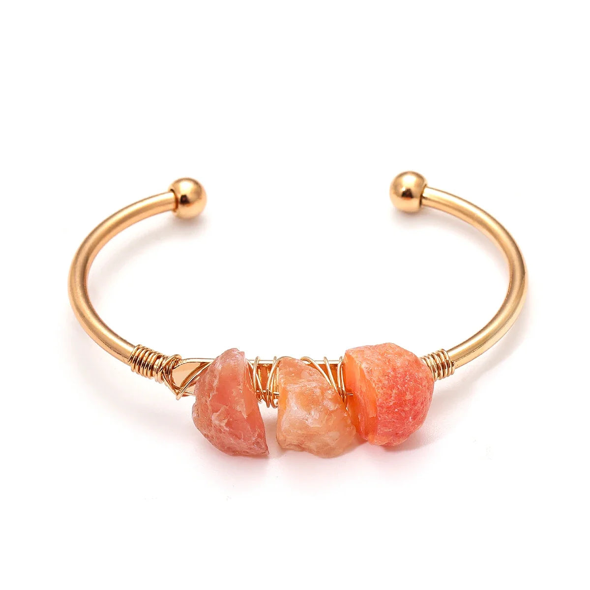Gold bracelet with pink stone beads on a white background