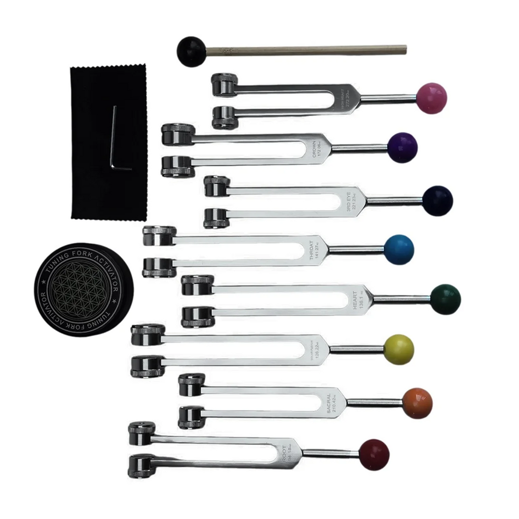 Set of tuning forks with colored ends on a white background