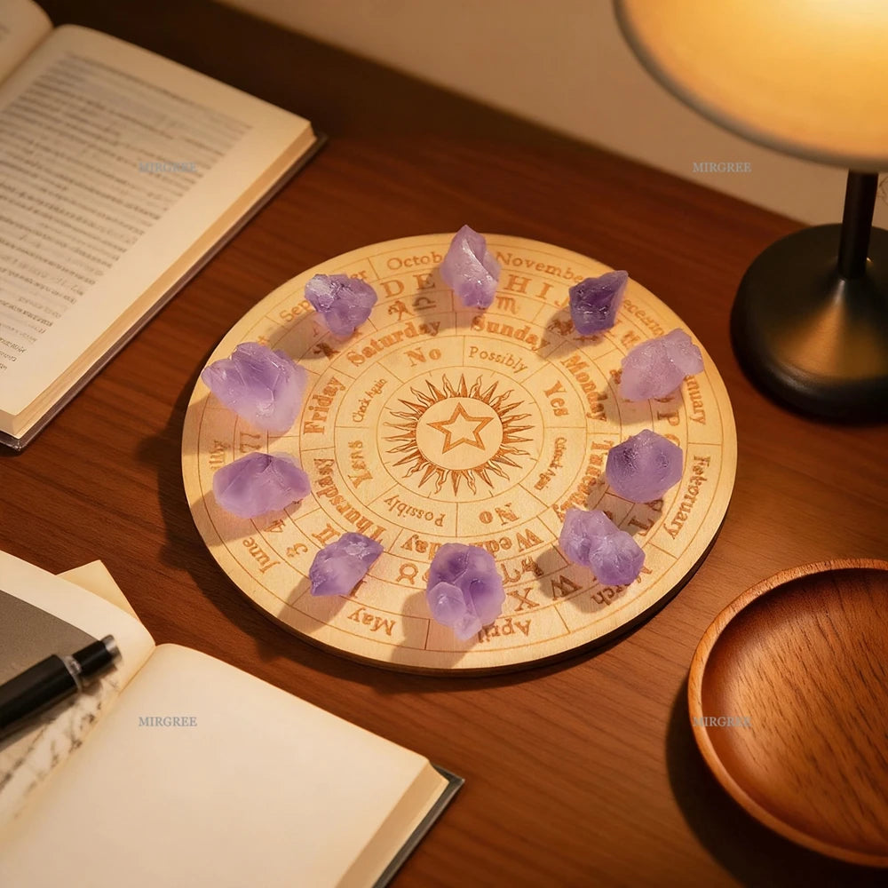 Purple crystals on a circular astrological chart on a wooden table with books and a lamp.